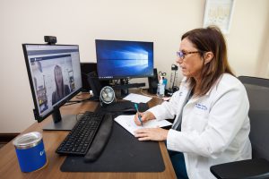 Lea Ann Coxwell, a nurse practitioner in the UMMC Center for Telehealth, conducts a telehealth visit to discuss a student's care with Jana Miller, a registered nurse serving as school nurse in Greene County.